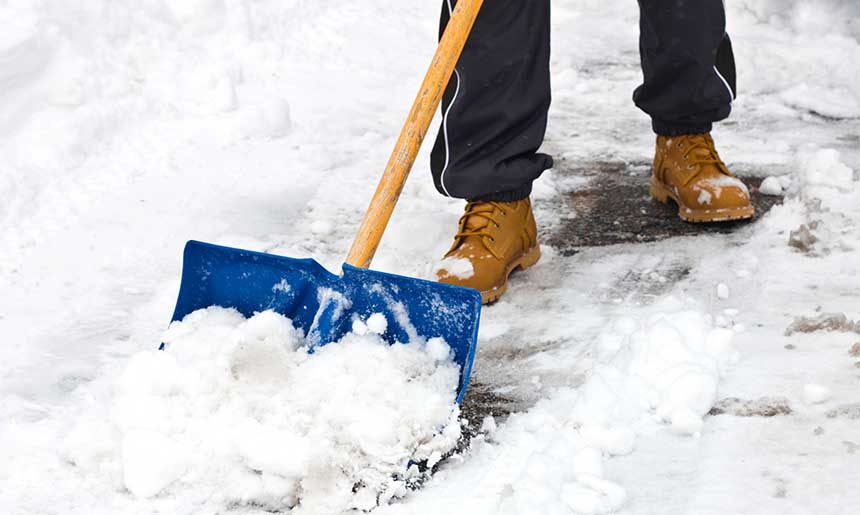 Clearing snow with shovel after storm