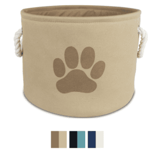 A beige round fabric toy bin with a paw print design and side rope handles, accompanied by a color palette below.