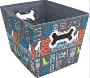 A colorful dog-themed toy bin with words and bone shapes printed on it.