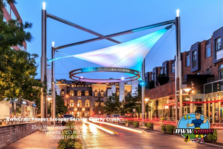 An urban evening setting with a colorful neon-lit structure and advertisements for a pet waste removal service.